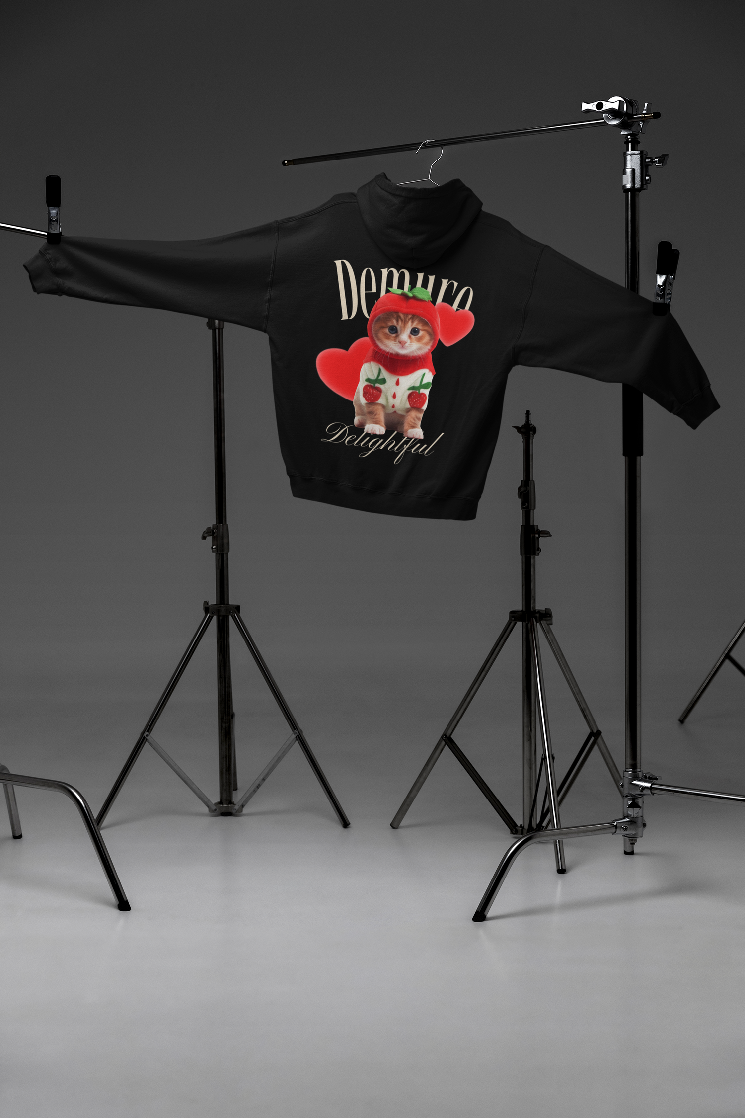 Very Demure, Very Delightful hoodie on tripod stands, back view